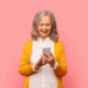 older lady holding a cellphone and smiling